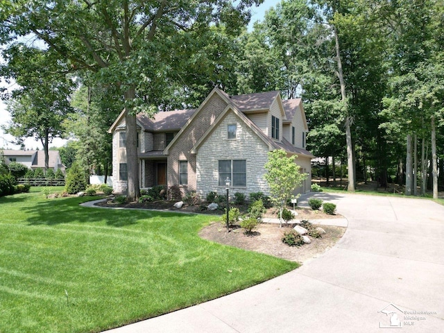 9241 Legacy Ct, Temperance, MI 48182 - view of front of property with stone siding, concrete driveway, and an attached garage