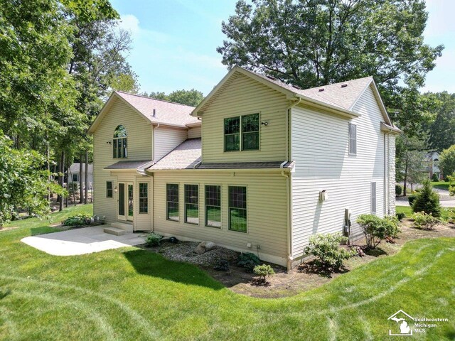 9241 Legacy Ct, Temperance, MI 48182 - rear view of property featuring a patio, a yard, entry steps, and roof with shingles