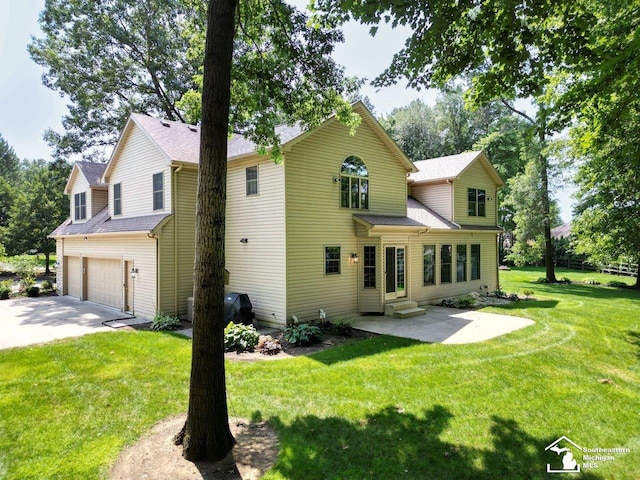 9241 Legacy Ct, Temperance, MI 48182 - back of house with entry steps, an attached garage, a lawn, concrete driveway, and roof with shingles