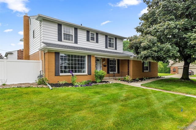 18607 Colonial Ct, Allen Park, MI 48101 - traditional-style home featuring covered porch, brick siding, and a chimney