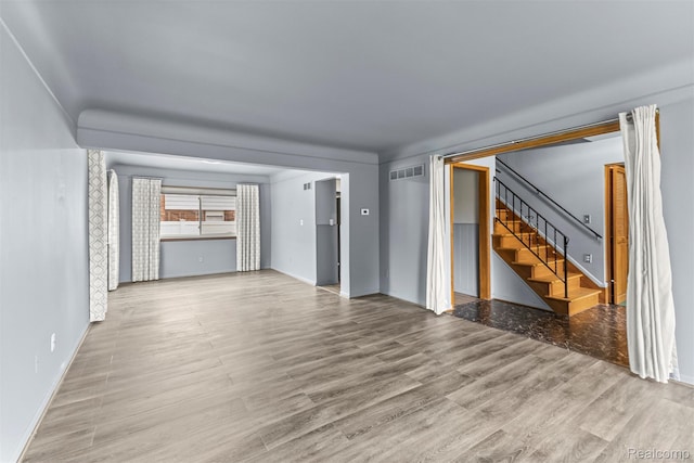 18607 Colonial Ct, Allen Park, MI 48101 - unfurnished living room with wood finished floors, stairway, and baseboards