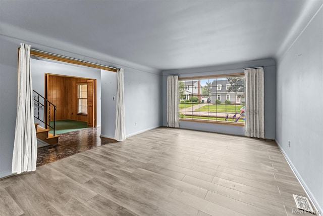 18607 Colonial Ct, Allen Park, MI 48101 - empty room with wood finished floors, stairs, and baseboards