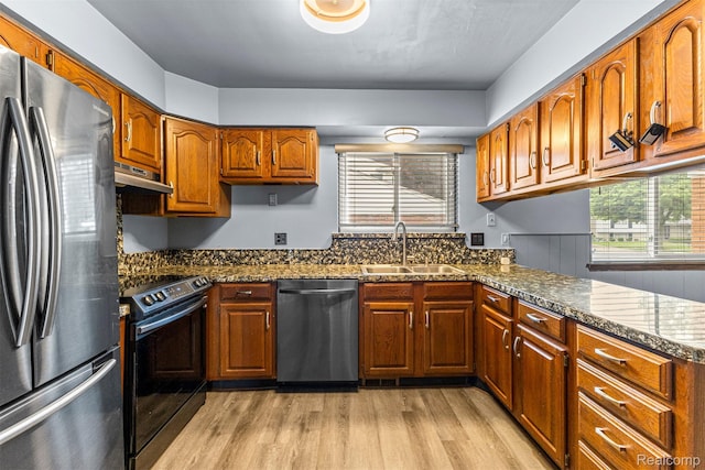 18607 Colonial Ct, Allen Park, MI 48101 - kitchen with stainless steel appliances, extractor fan, a sink, light wood-type flooring, and brown cabinets