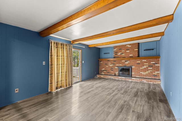 18607 Colonial Ct, Allen Park, MI 48101 - unfurnished living room with wood finished floors, beamed ceiling, and a brick fireplace