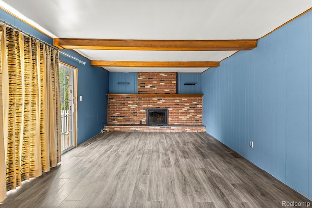 18607 Colonial Ct, Allen Park, MI 48101 - unfurnished living room featuring wood finished floors, beamed ceiling, and a fireplace