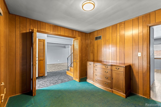 18607 Colonial Ct, Allen Park, MI 48101 - bedroom featuring dark carpet, wooden walls, and a closet