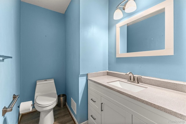 18607 Colonial Ct, Allen Park, MI 48101 - bathroom with vanity, toilet, and wood finished floors