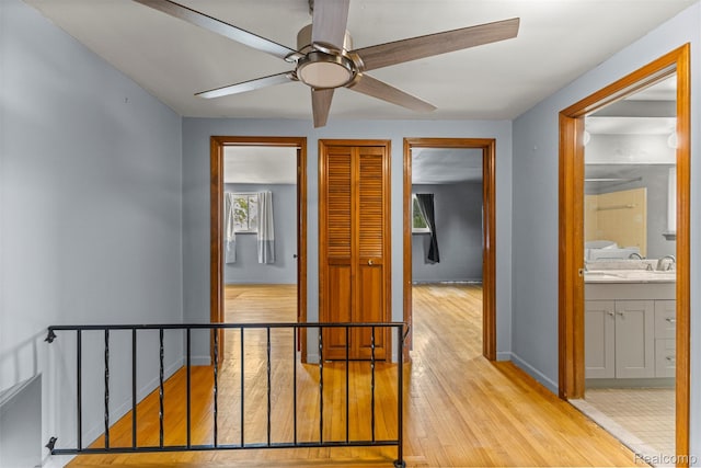 18607 Colonial Ct, Allen Park, MI 48101 - corridor with wood finished floors, baseboards, and an upstairs landing