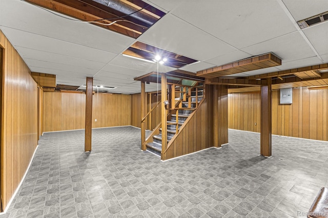 18607 Colonial Ct, Allen Park, MI 48101 - finished below grade area with wood walls, stairs, electric panel, baseboards, and a paneled ceiling