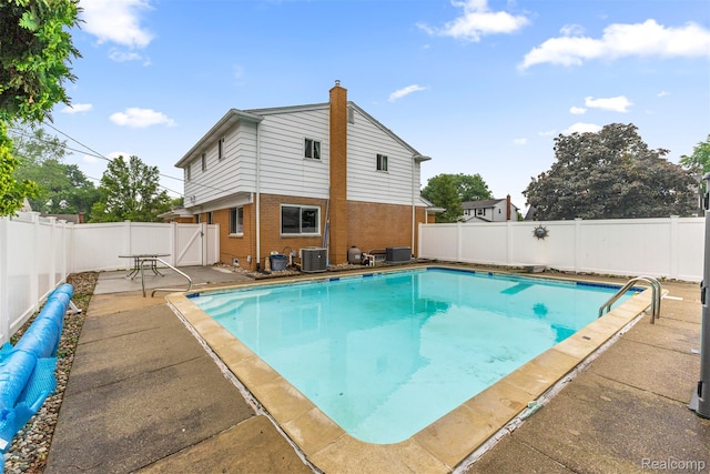 18607 Colonial Ct, Allen Park, MI 48101 - view of pool featuring central AC unit, a fenced backyard, a patio area, and a gate