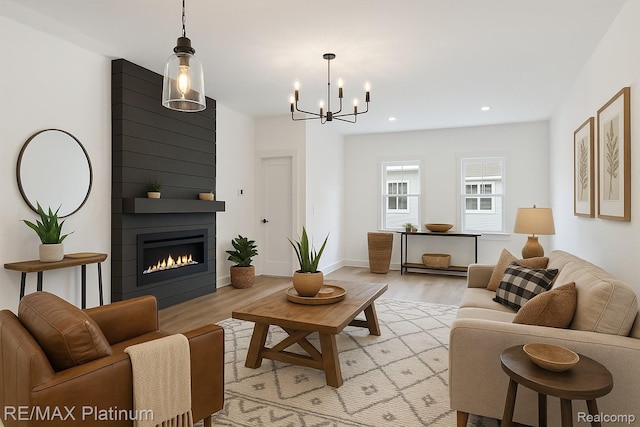 1685 Pinecroft Ln, Howell, MI 48855 - living room featuring light wood finished floors, a chandelier, recessed lighting, a fireplace, and baseboards