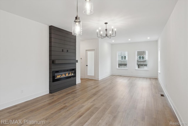 1685 Pinecroft Ln, Howell, MI 48855 - unfurnished living room with wood finished floors, a large fireplace, a chandelier, baseboards, and recessed lighting