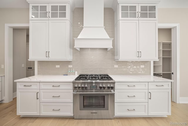 4174 Prescott Park Cir W, Bloomfield, MI 48323 - kitchen with high end stove, white cabinets, custom range hood, and tasteful backsplash