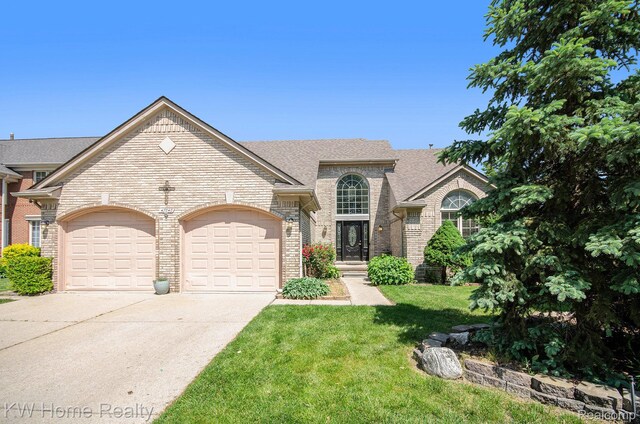 47040 W Wayford Dr, Shelby Twp, MI 48315 - view of front of house featuring brick siding, a garage, driveway, a front lawn, and roof with shingles