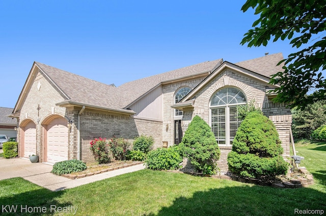 47040 W Wayford Dr, Shelby Twp, MI 48315 - view of front facade featuring brick siding, roof with shingles, an attached garage, and a front yard