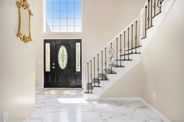 47040 W Wayford Dr, Shelby Twp, MI 48315 - entrance foyer featuring marble tiled flooring, a towering ceiling, baseboards, and stairway