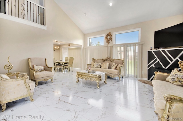 47040 W Wayford Dr, Shelby Twp, MI 48315 - living room featuring high vaulted ceiling, marble finish flooring, a chandelier, and baseboards