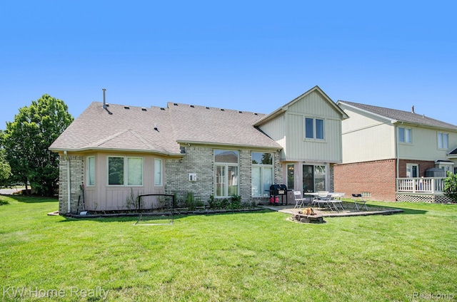 47040 W Wayford Dr, Shelby Twp, MI 48315 - back of house with an outdoor fire pit, brick siding, a yard, and a patio area
