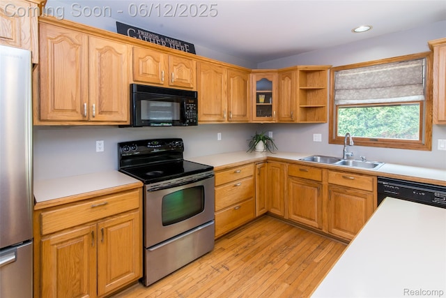 10399 Allen Rd, Clarkston, MI 48348 - kitchen with stainless steel appliances, a sink, light wood finished floors, light countertops, and recessed lighting