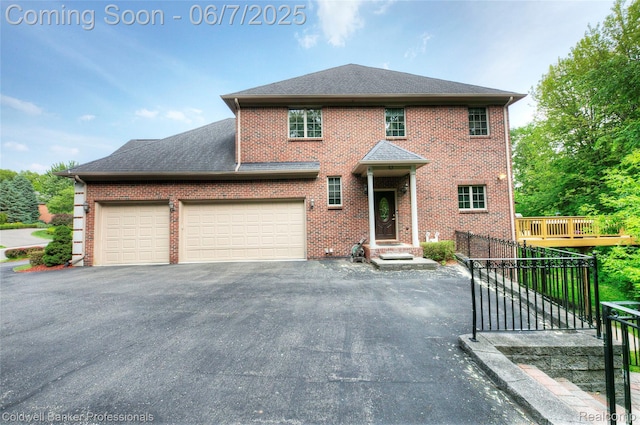 4546 Forest Edge Ln, West Bloomfield, MI 48323 - view of front of house featuring brick siding, asphalt driveway, and a garage