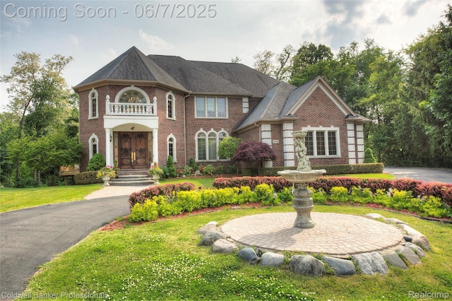 4546 Forest Edge Ln, West Bloomfield, MI 48323 - georgian-style home with brick siding and a front yard