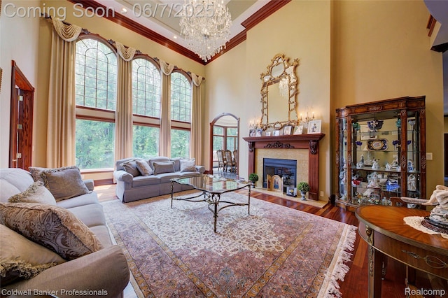 4546 Forest Edge Ln, West Bloomfield, MI 48323 - living area featuring a high ceiling, crown molding, a chandelier, wood finished floors, and a high end fireplace