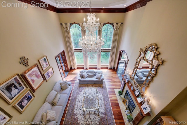4546 Forest Edge Ln, West Bloomfield, MI 48323 - living room featuring a towering ceiling, ornamental molding, a chandelier, and wood finished floors