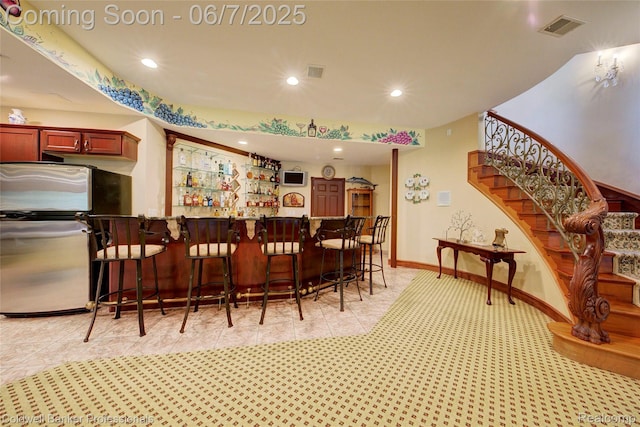 4546 Forest Edge Ln, West Bloomfield, MI 48323 - indoor dry bar featuring stairway, recessed lighting, light tile patterned floors, freestanding refrigerator, and light carpet