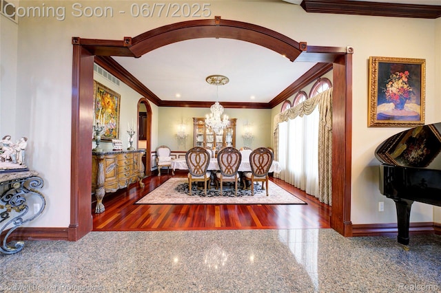 4546 Forest Edge Ln, West Bloomfield, MI 48323 - dining space featuring crown molding, granite tiled floors, a chandelier, arched walkways, and baseboards