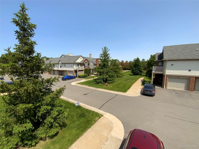 3577 Oakmonte Blvd, Rochester, MI 48306 - view of front of home featuring a residential view, a balcony, driveway, and a front yard