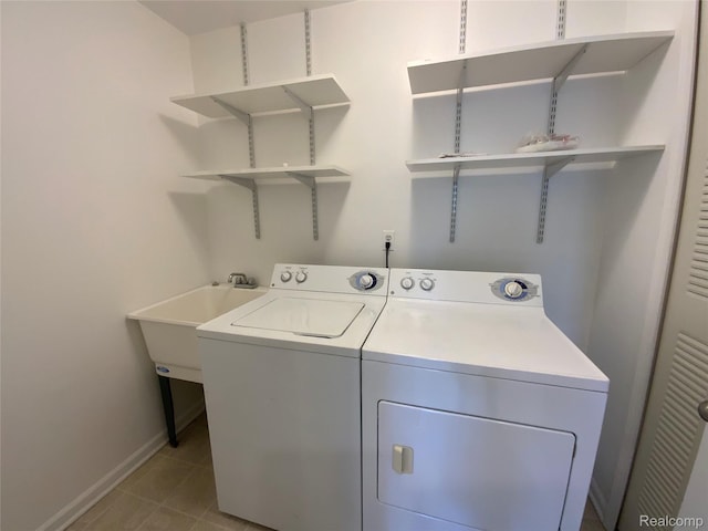 3577 Oakmonte Blvd, Rochester, MI 48306 - laundry area with washer and clothes dryer, baseboards, and light tile patterned flooring