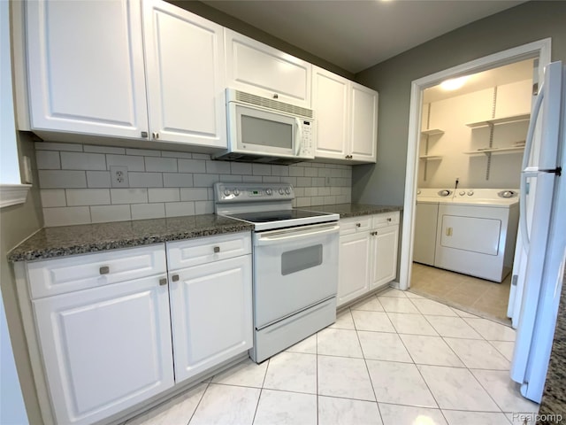 3577 Oakmonte Blvd, Rochester, MI 48306 - kitchen with white appliances, washer and clothes dryer, white cabinets, and tasteful backsplash