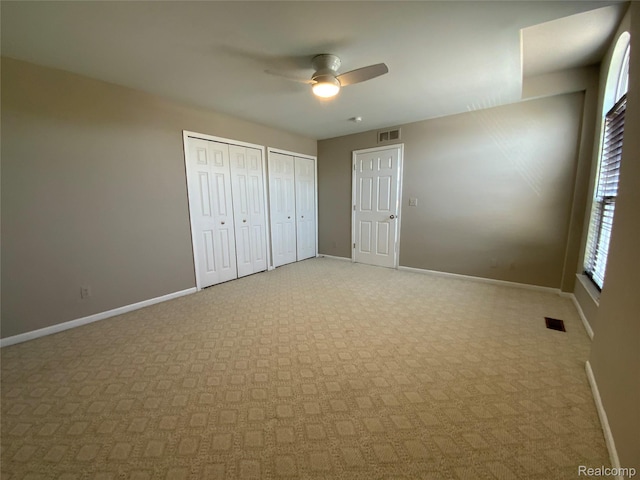 3577 Oakmonte Blvd, Rochester, MI 48306 - unfurnished bedroom featuring multiple closets, baseboards, and light carpet