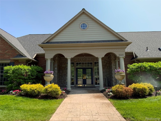3577 Oakmonte Blvd, Rochester, MI 48306 - doorway to property featuring french doors, roof with shingles, stone siding, and covered porch