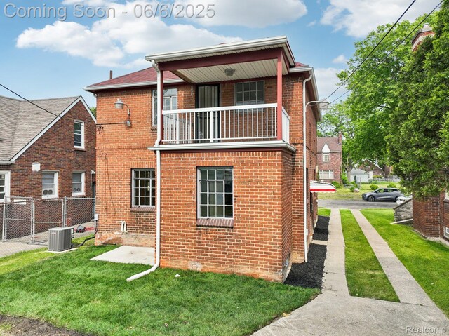 17321 Snowden St, Detroit, MI 48235 - rear view of house featuring a balcony, brick siding, and cooling unit