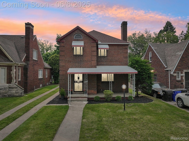 17321 Snowden St, Detroit, MI 48235 - traditional-style house with brick siding, covered porch, a front lawn, and a chimney