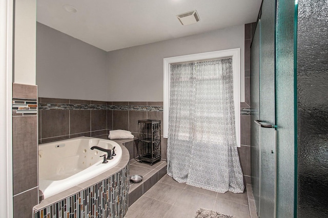 371 Waukazoo Dr, Holland, MI 49424 - bathroom featuring a tub with jets, tile patterned floors, and tile walls