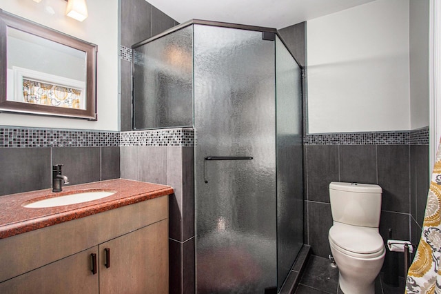 371 Waukazoo Dr, Holland, MI 49424 - bathroom with tile walls, vanity, tile patterned floors, a stall shower, and toilet