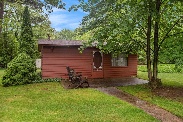 371 Waukazoo Dr, Holland, MI 49424 - view of front of property with a front lawn and roof with shingles