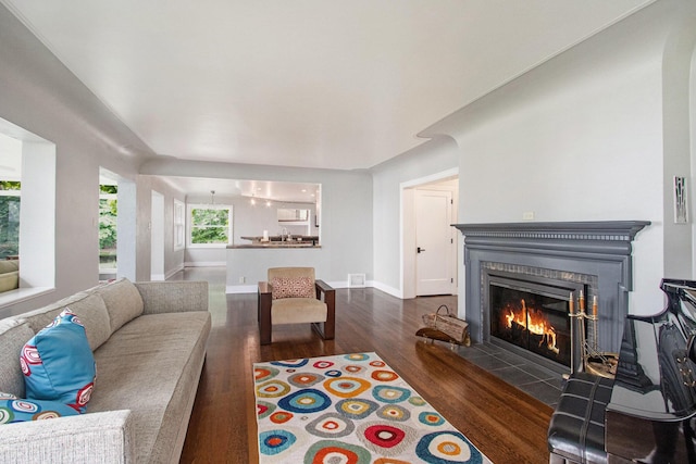 371 Waukazoo Dr, Holland, MI 49424 - living area featuring a tile fireplace, wood finished floors, and baseboards