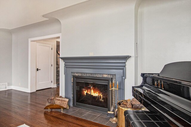 371 Waukazoo Dr, Holland, MI 49424 - detailed view of wood finished floors, a fireplace with flush hearth, and baseboards