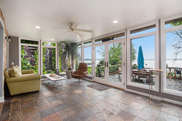 371 Waukazoo Dr, Holland, MI 49424 - sunroom / solarium with french doors, floor to ceiling windows, a water view, plenty of natural light, and stone tile flooring