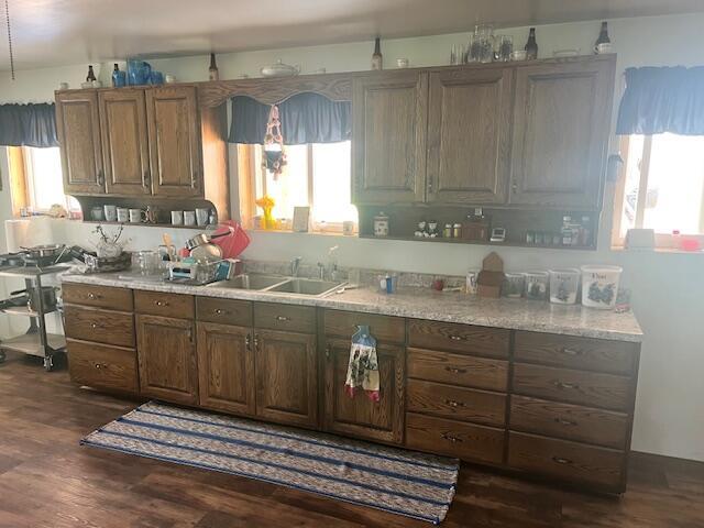 5195 Chief Rd, Brethren, MI 49619 - kitchen with a sink, dark wood-style flooring, light countertops, and brown cabinetry