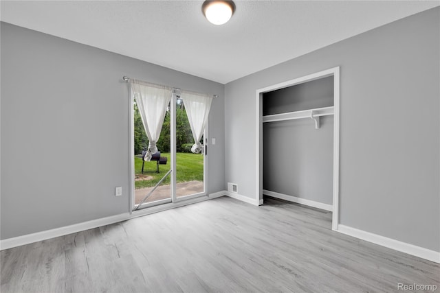 27048 Sally Ct, Taylor, MI 48180 - unfurnished bedroom with access to exterior, wood finished floors, baseboards, and a closet