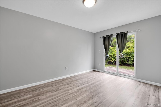 27048 Sally Ct, Taylor, MI 48180 - empty room with wood finished floors and baseboards