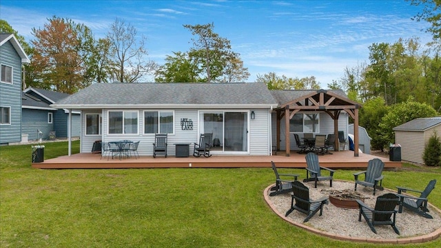 4805 Pinellas Dr, Hale, MI 48739 - rear view of house featuring a fire pit, a deck, a gazebo, and outdoor dining space