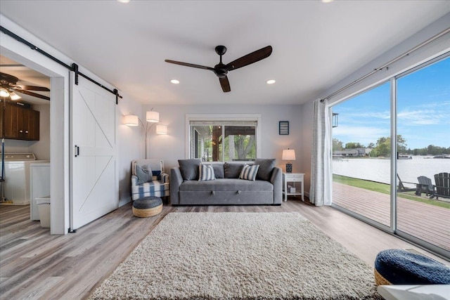 4805 Pinellas Dr, Hale, MI 48739 - living room with a ceiling fan, a barn door, a water view, light wood-type flooring, and recessed lighting