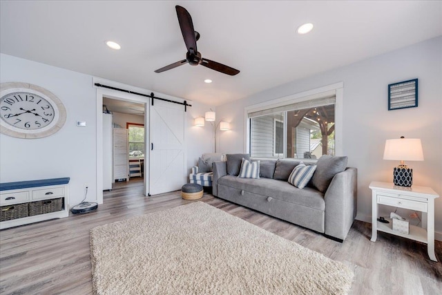 4805 Pinellas Dr, Hale, MI 48739 - living room with ceiling fan, a barn door, light wood-type flooring, recessed lighting, and baseboards