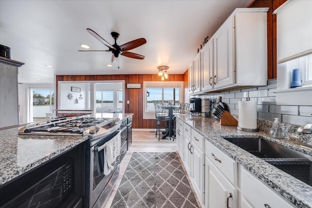 4805 Pinellas Dr, Hale, MI 48739 - kitchen with stainless steel range with gas stovetop, healthy amount of natural light, decorative backsplash, a ceiling fan, and recessed lighting