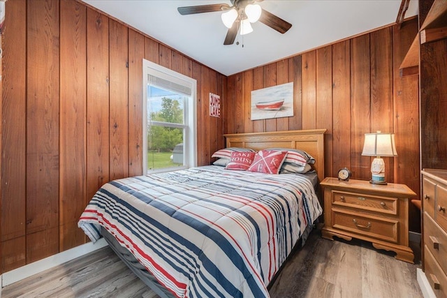 4805 Pinellas Dr, Hale, MI 48739 - bedroom featuring wood finished floors, wood walls, and a ceiling fan